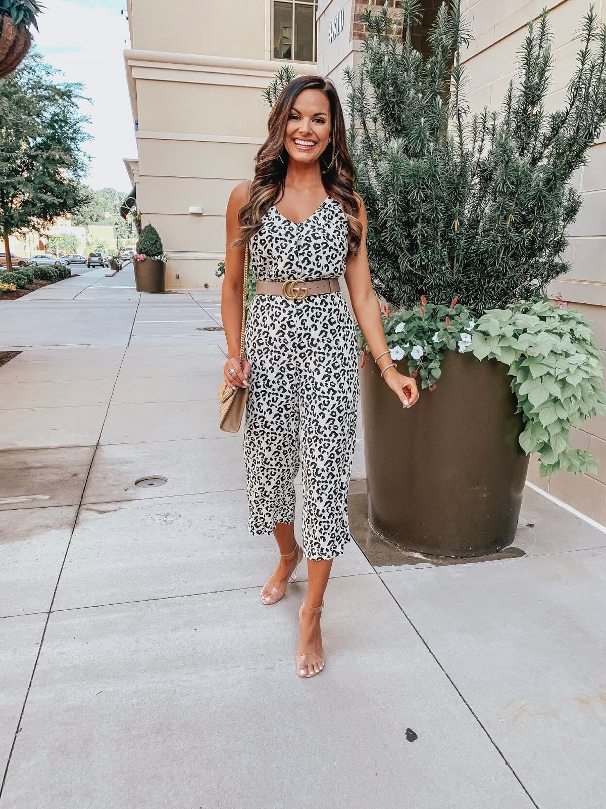 woman with printed jumpsuit walking on sidewalk