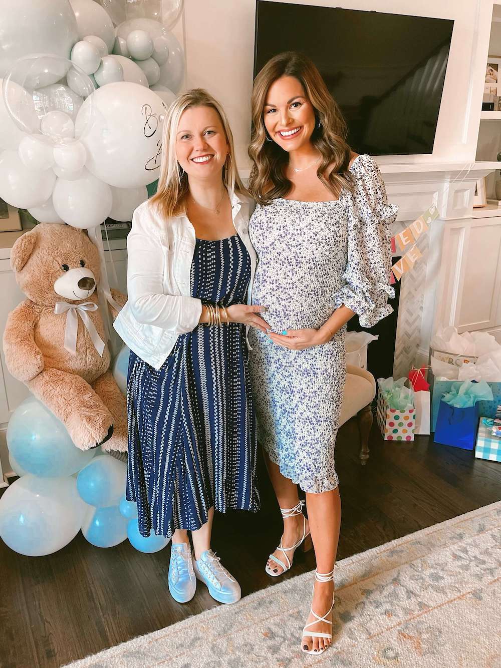 pregnant woman and friend in front of fireplace