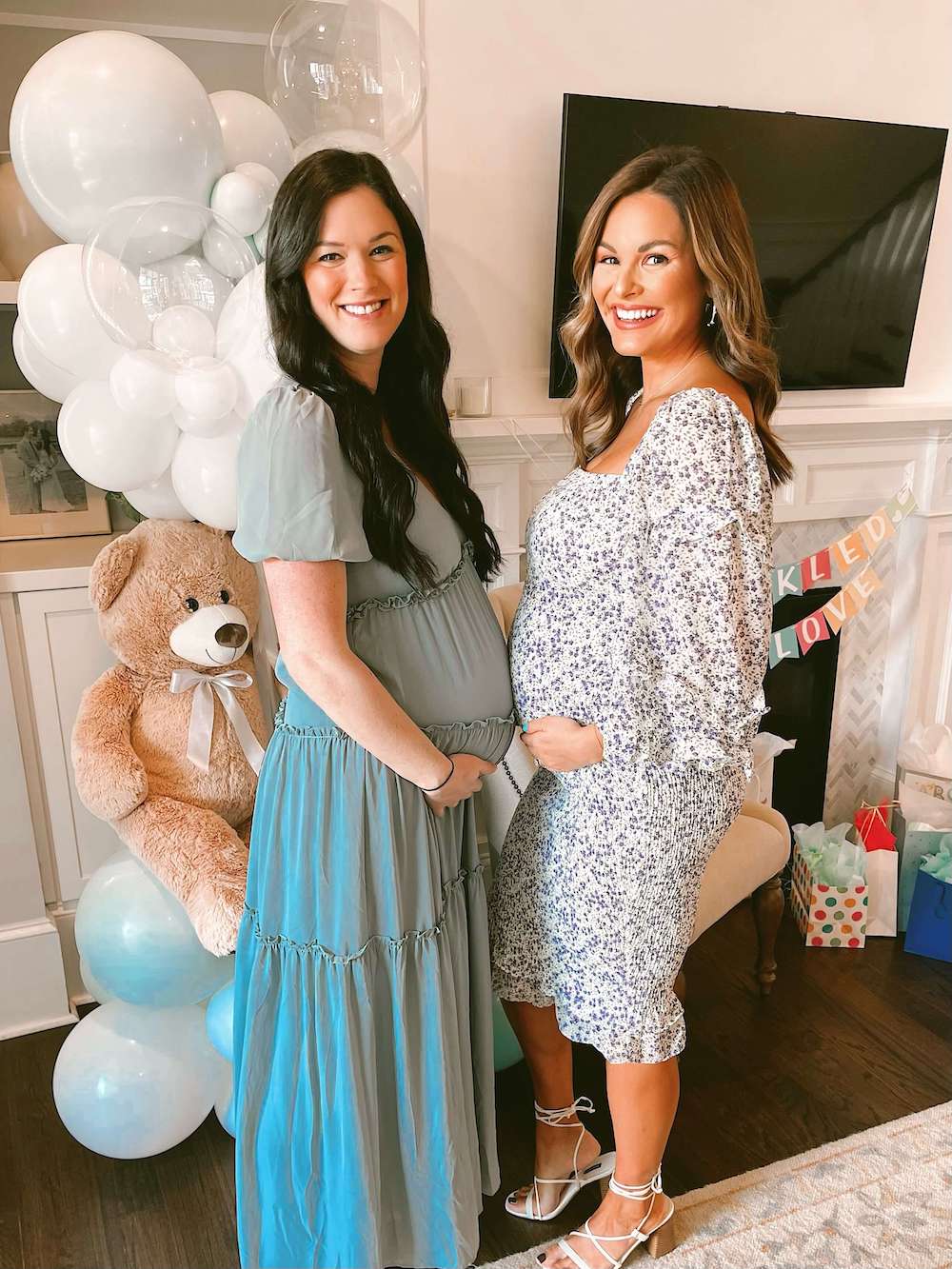 pregnant woman and friend in front of fireplace