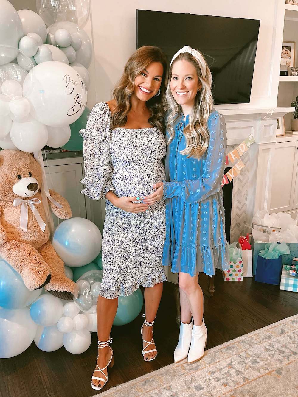 pregnant woman and friend in front of fireplace