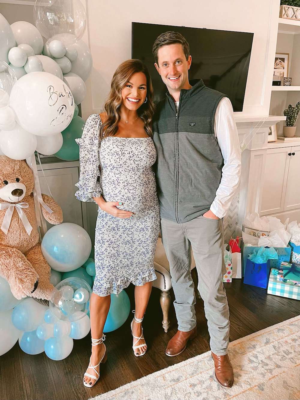 pregnant woman and man in front of fireplace