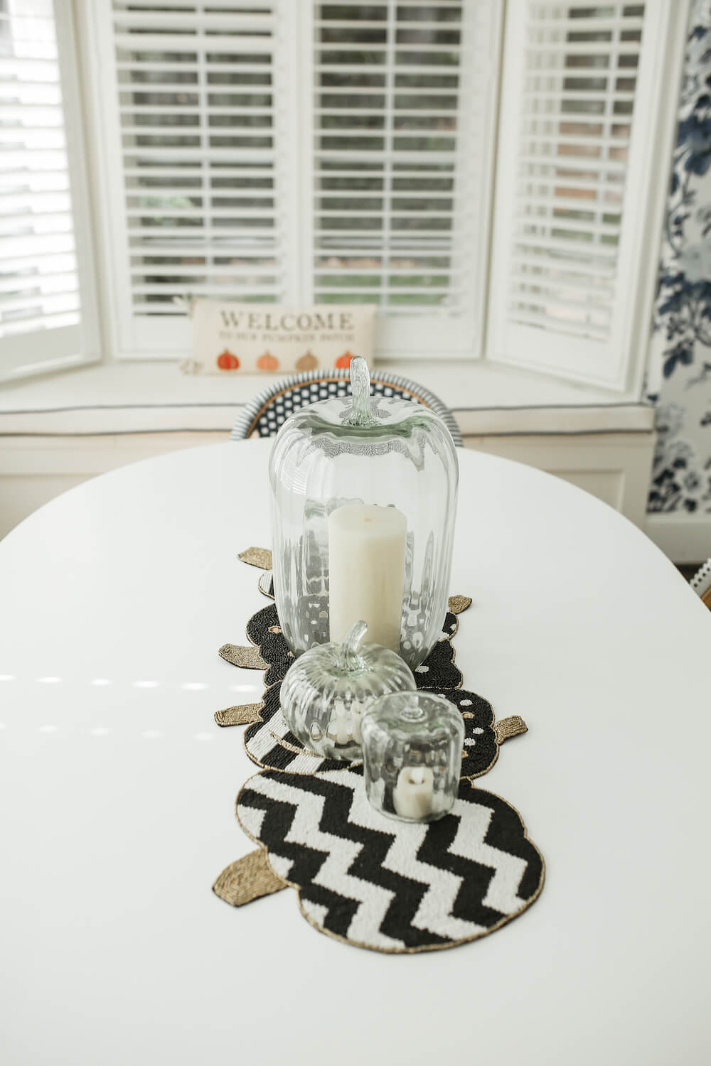 top view of table with black and white chevron pumpkin runner under glass cloches