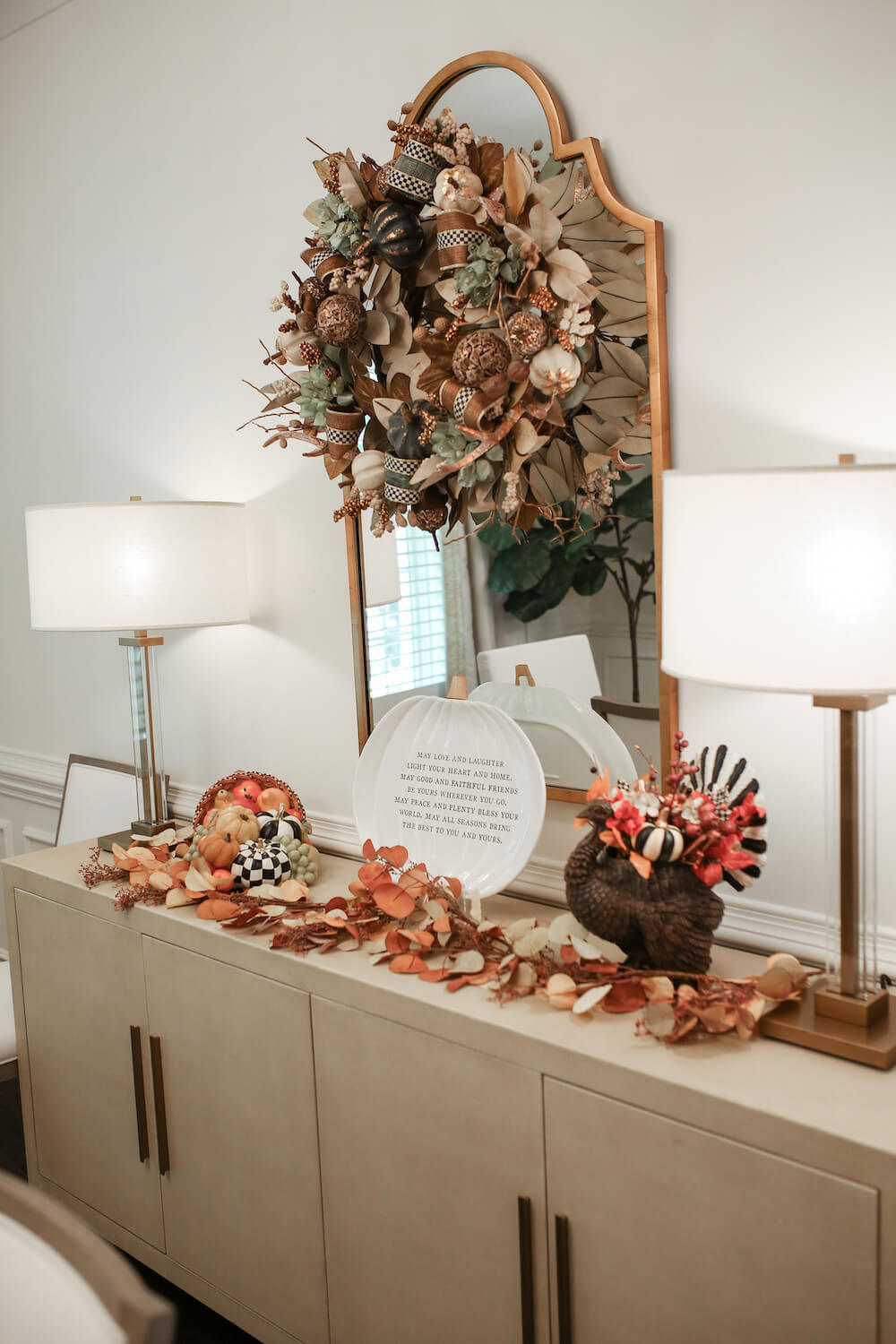 buffet table in dining room decorated for fall with mackenzie childs and plates with 2 lamps