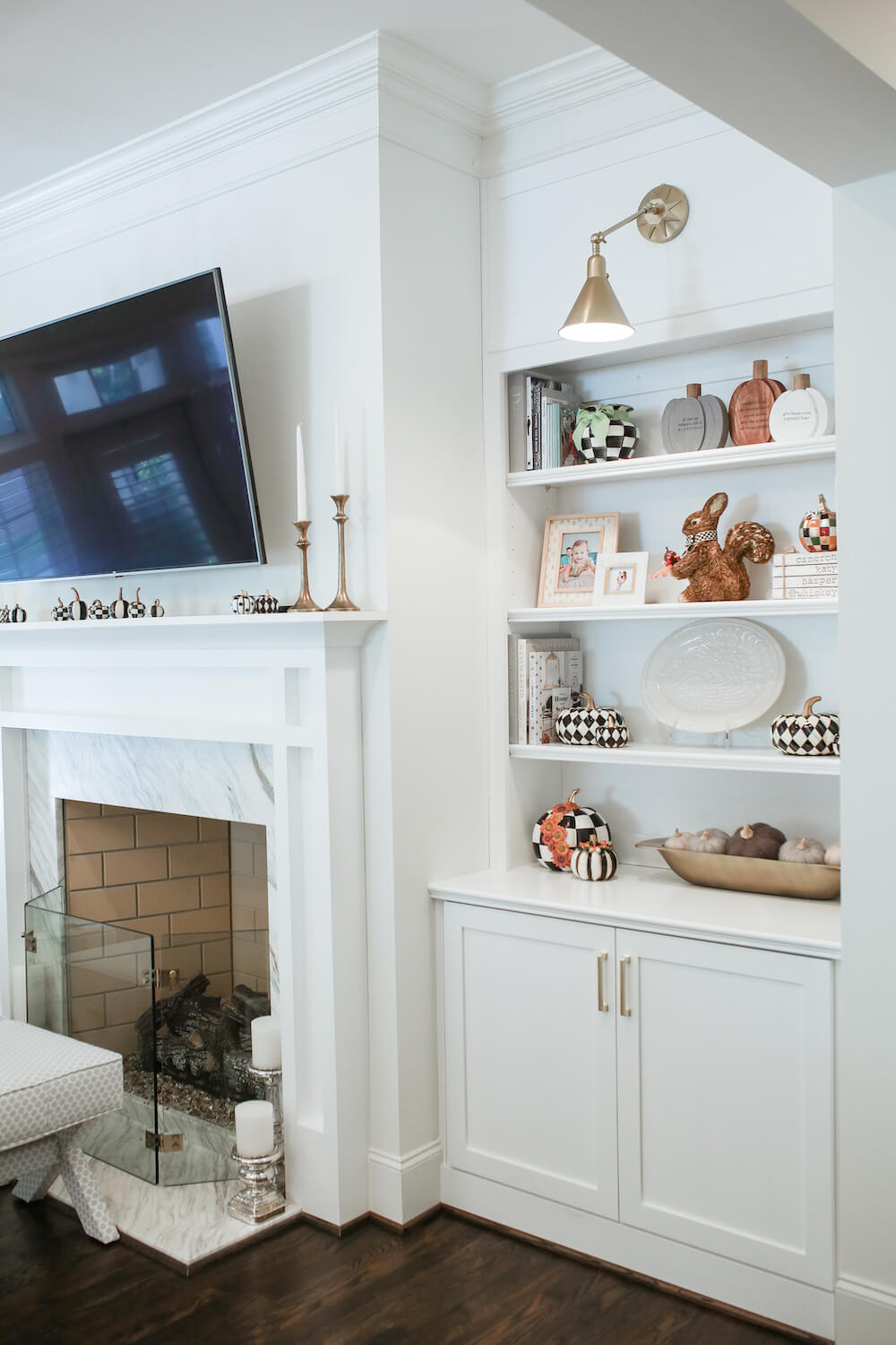 built in bookshelves next to fireplace in living room with fall decor