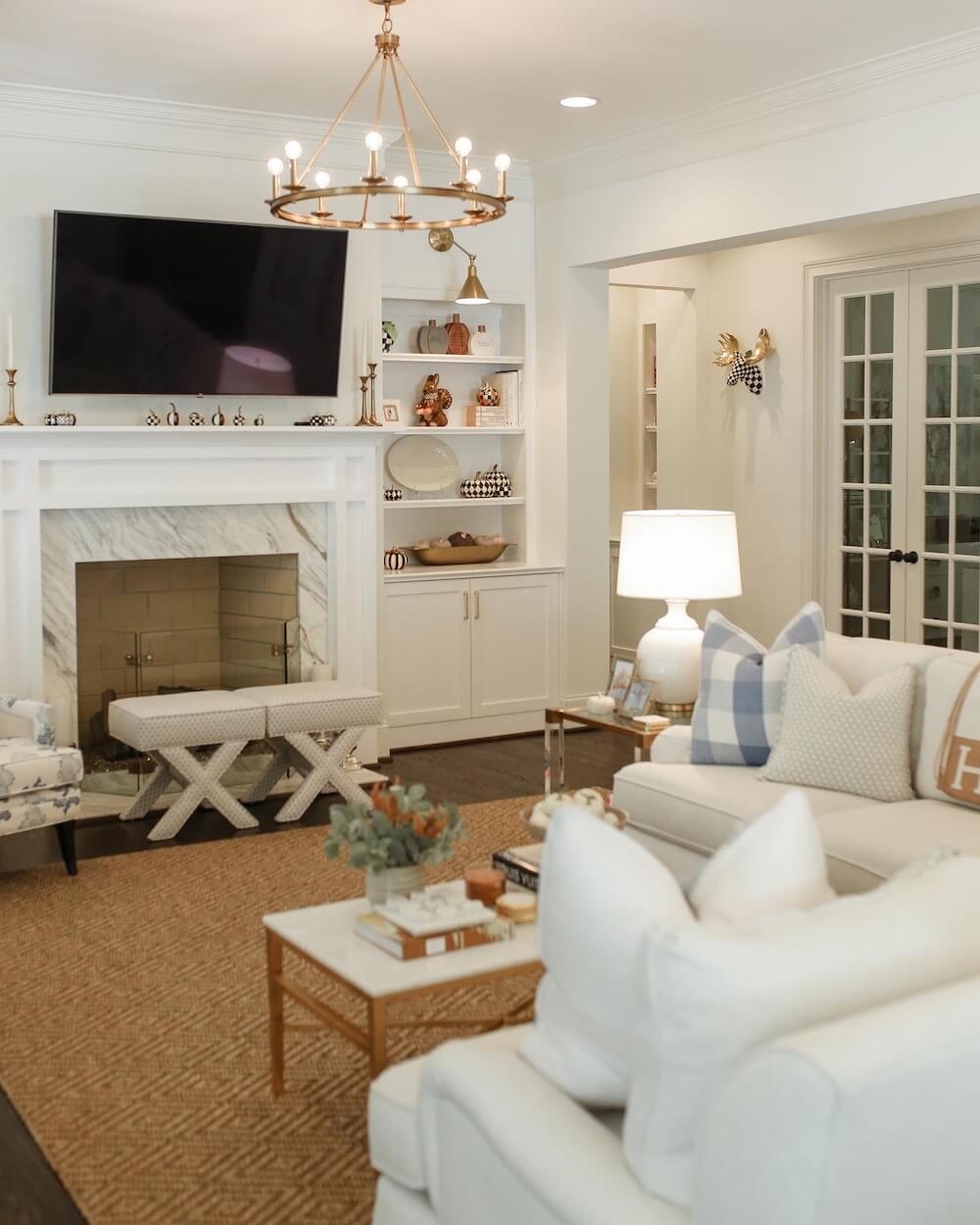 grandmillennial living room with white couch and fall decor