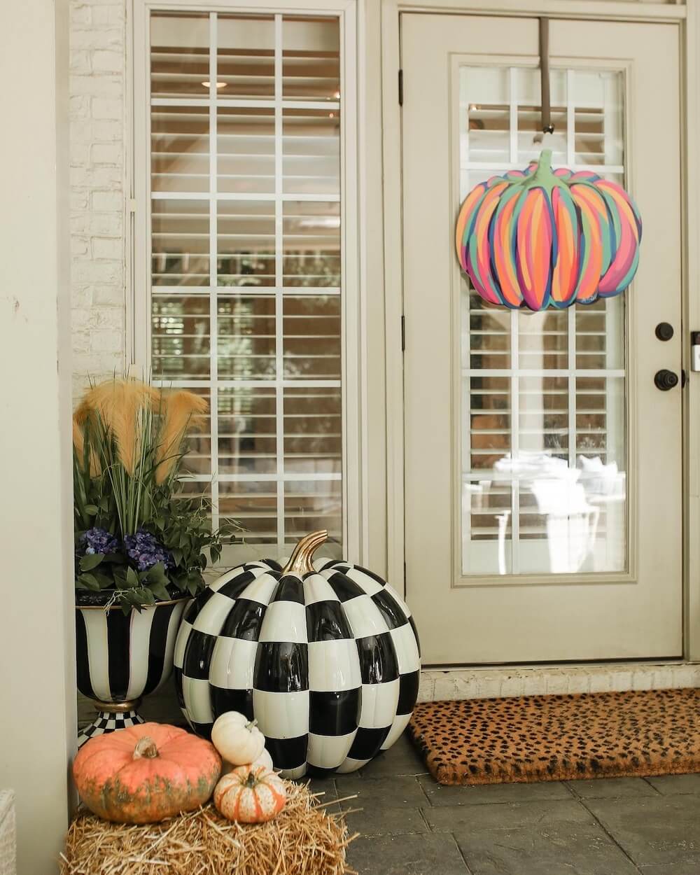 white french doors with colorful art door hanger