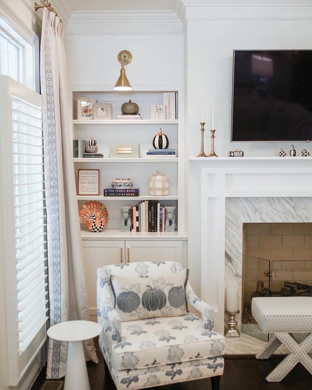 white bookshelves with fall decor from Mackenzie childs