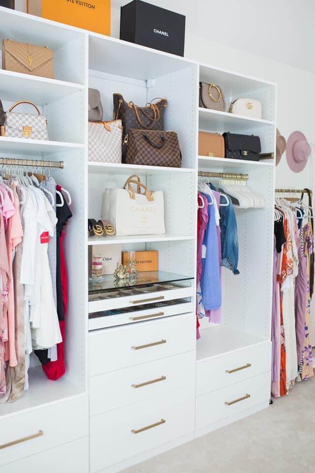 white closet system with gold hardware in small bedroom turned into a walk in closet