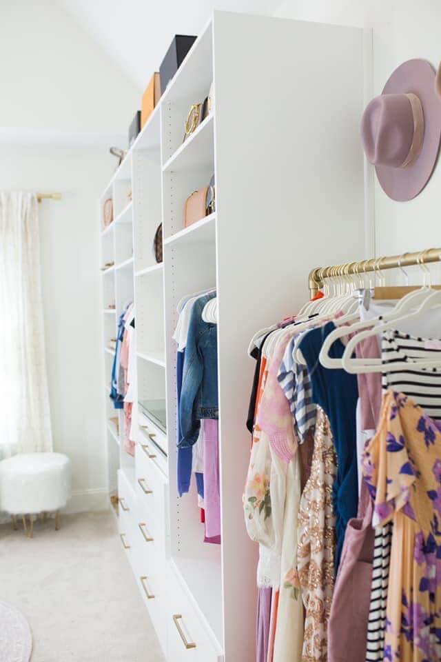 side view of white closet system in a small bedroom converted to a closet