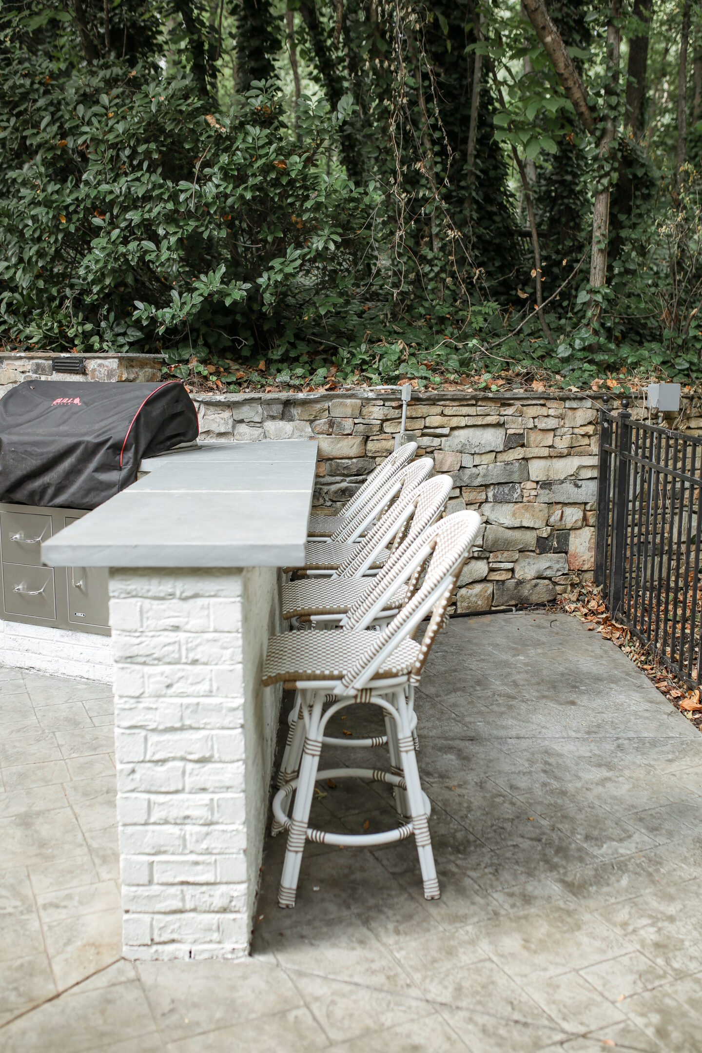 outdoor brick and concrete bar with serena and lily barstools