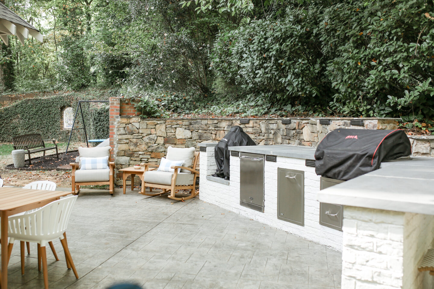 outdoor white modular kitchen with 2 oversized chairs