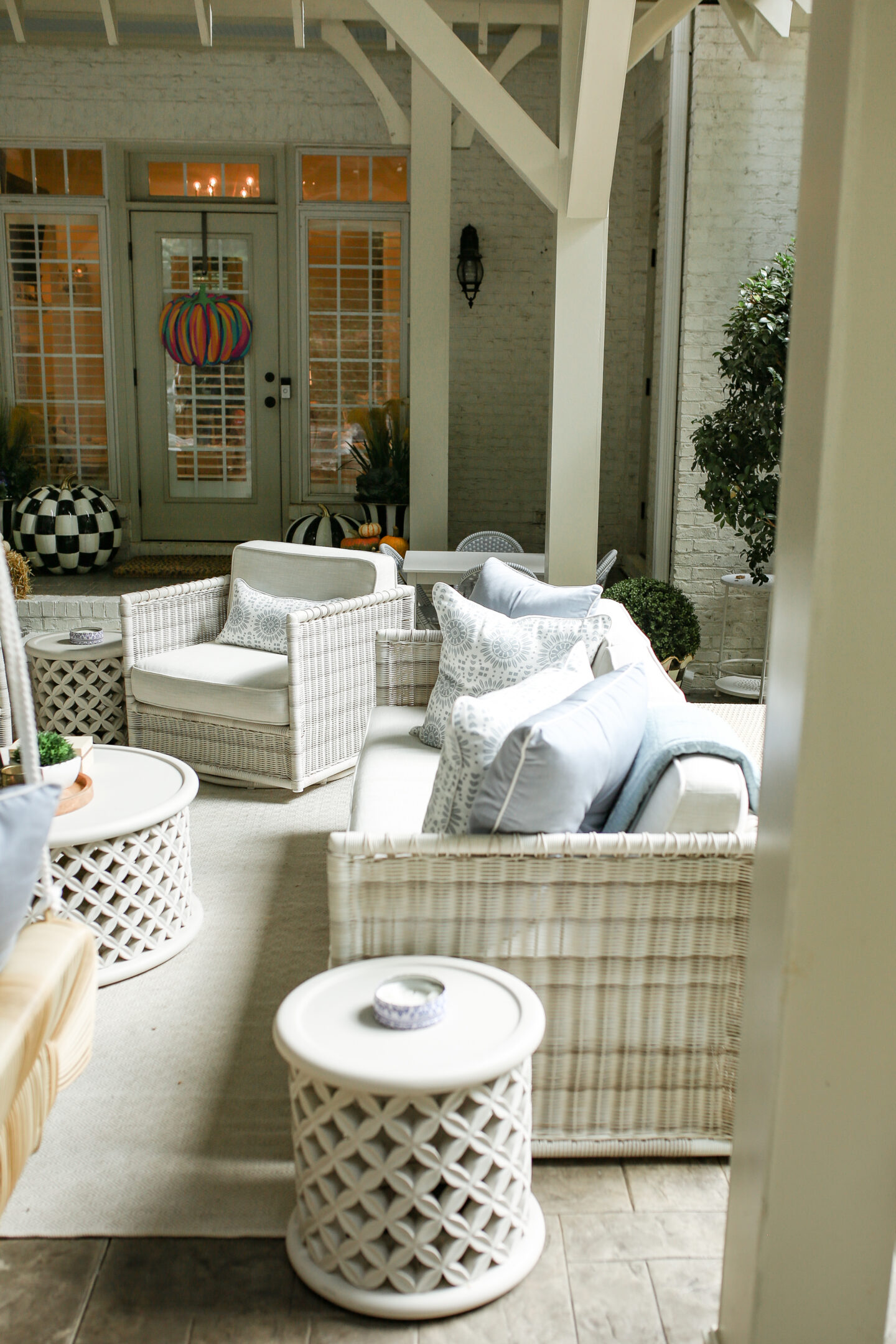 wicker furniture with white cushions on back patio