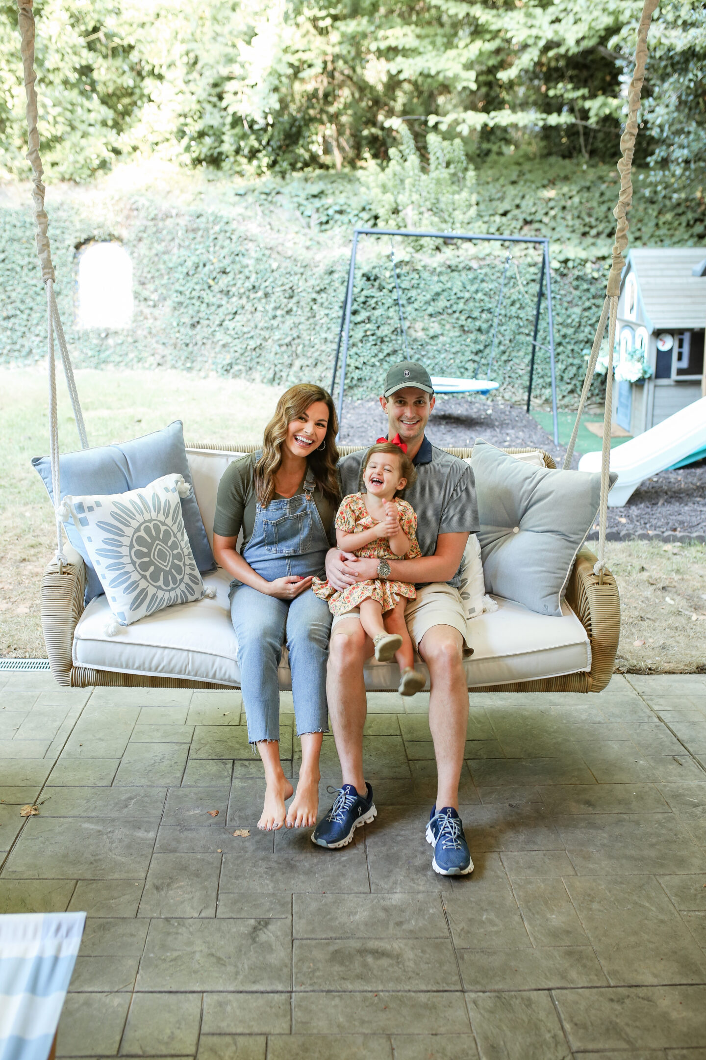 man and woman with little girl in their lap sitting on serena and lily outdoor daybed