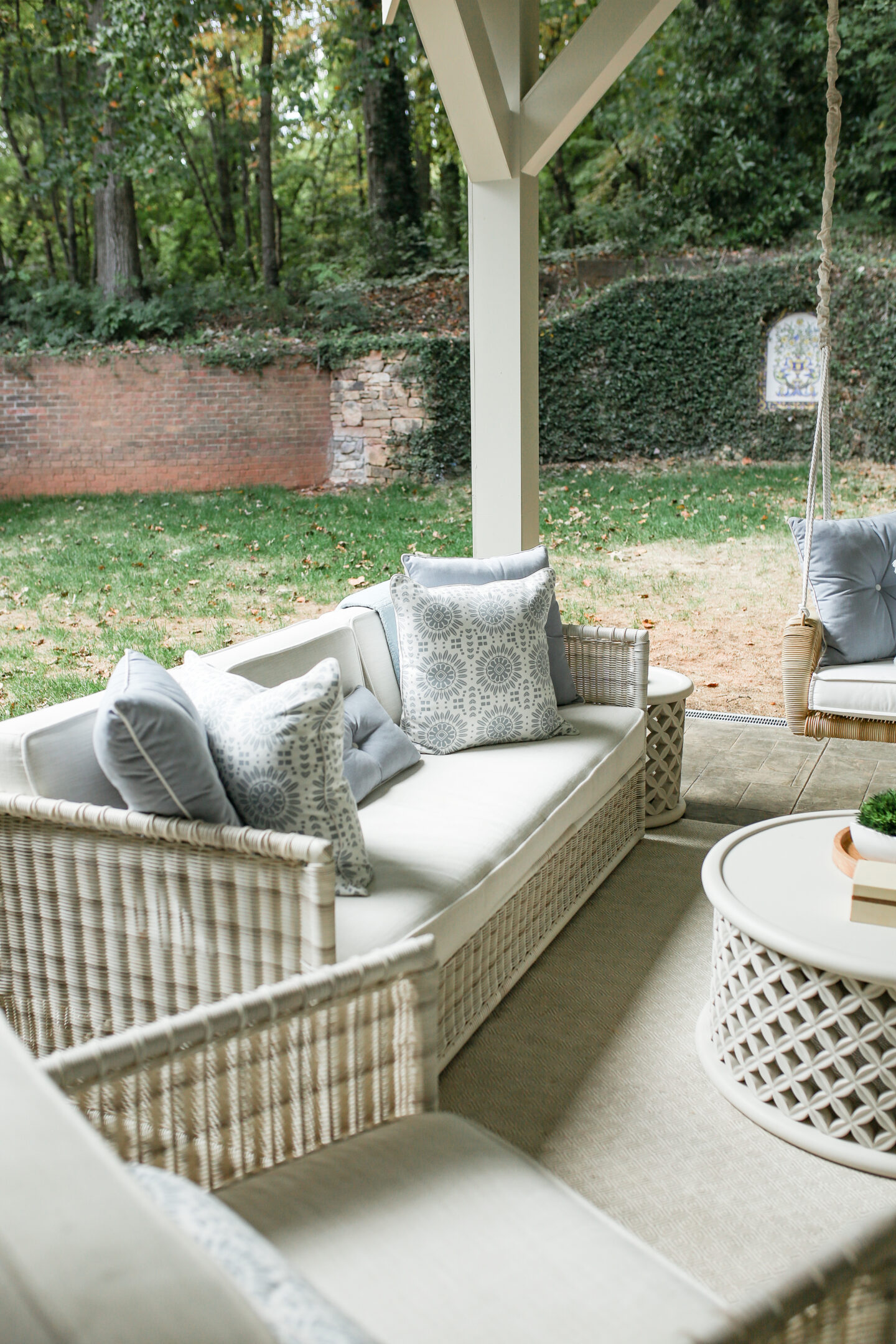 daybed swing with white cushions on back patio