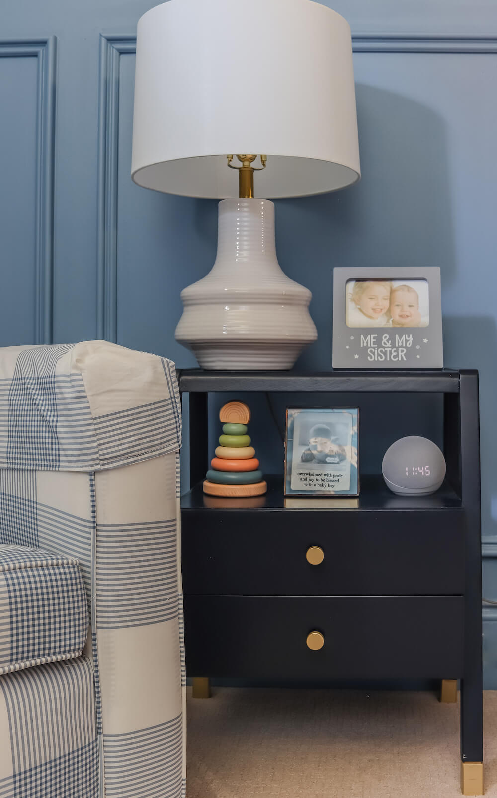 side table with white lamp next to nursery glider