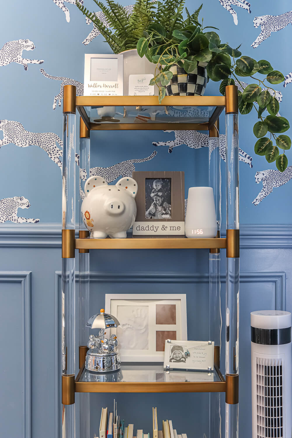 closeup of acrylic and gold shelves in a nursery