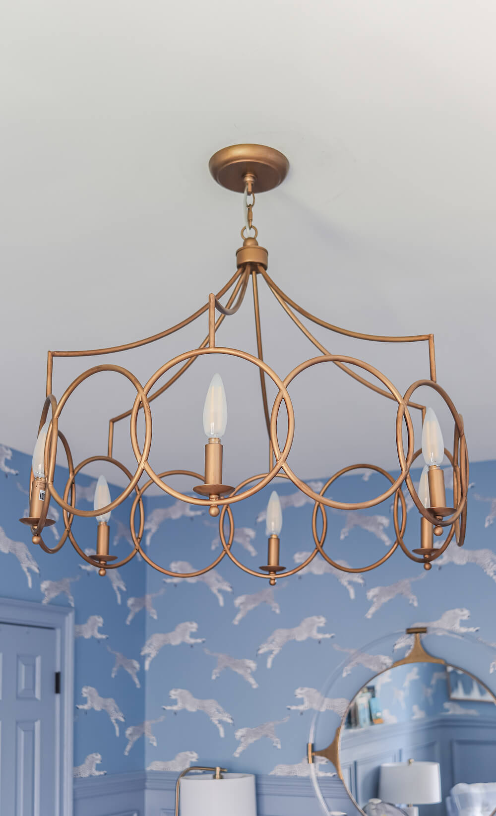 round gold light fixture in nursery