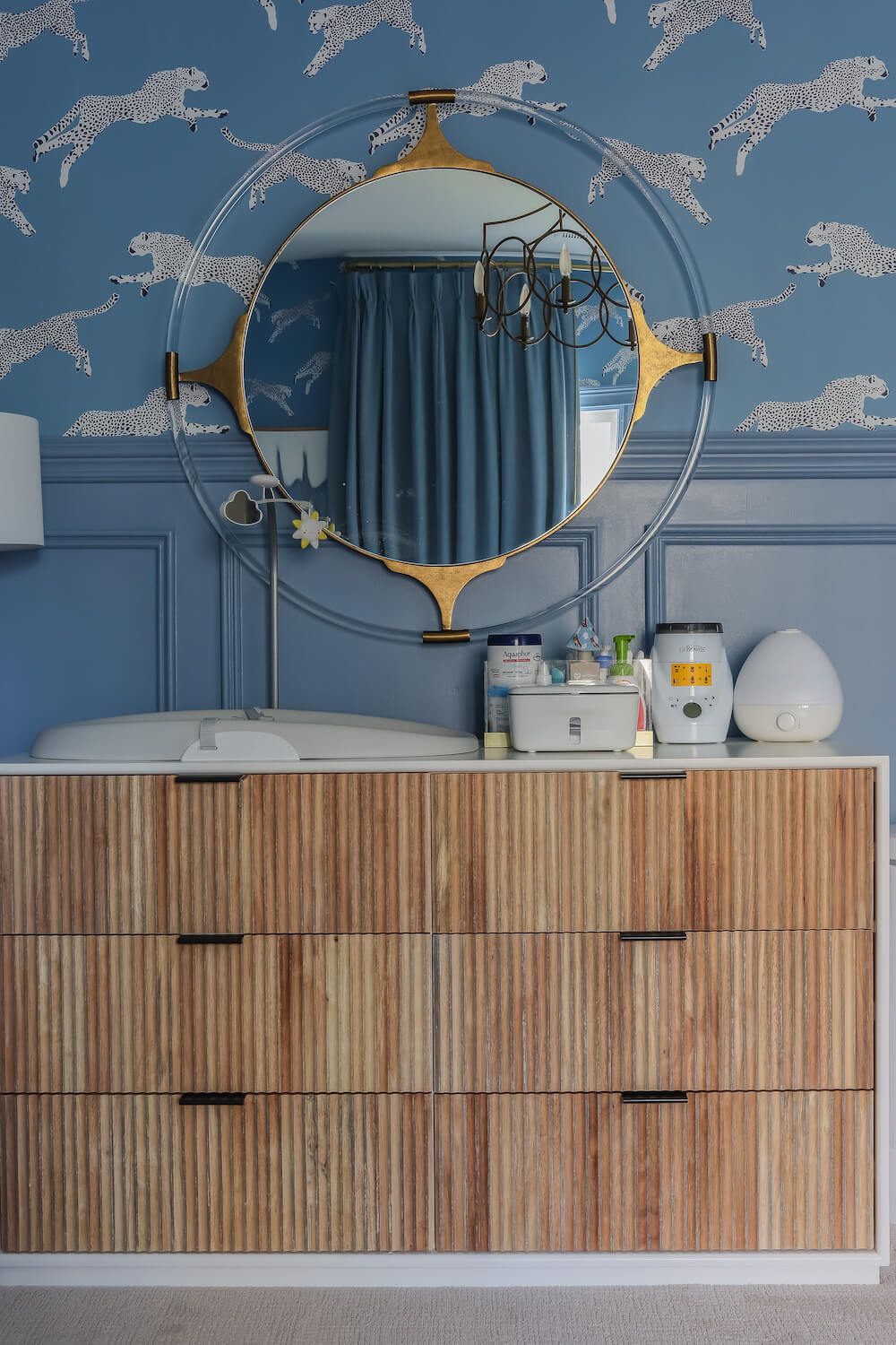 white dresser with wood fronts in front of benjamin moore denim wash walls