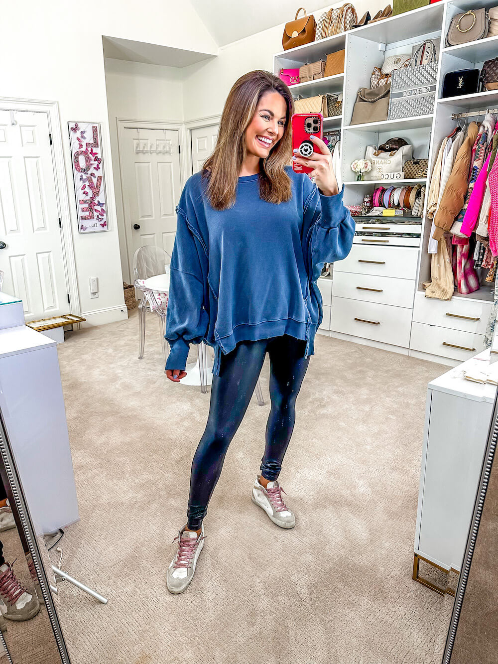 woman in blue sweater and leggings with golden goose sneakers