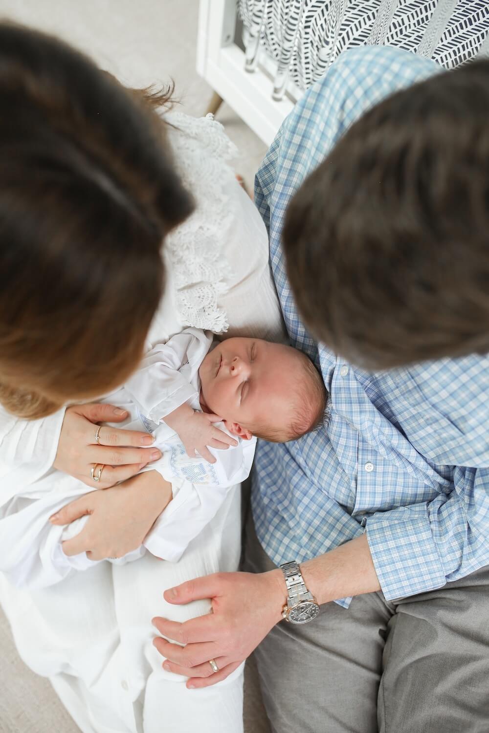 photo of mom and dad holding new baby boy