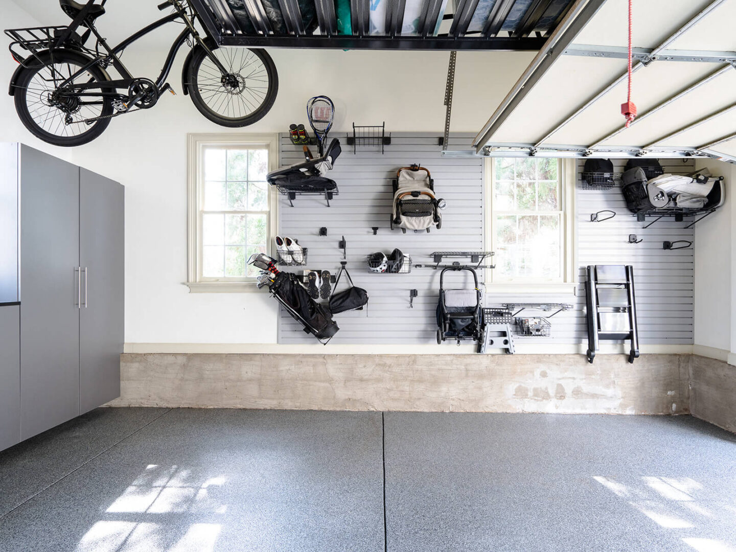 baby gear hanging up on slat wall in garage