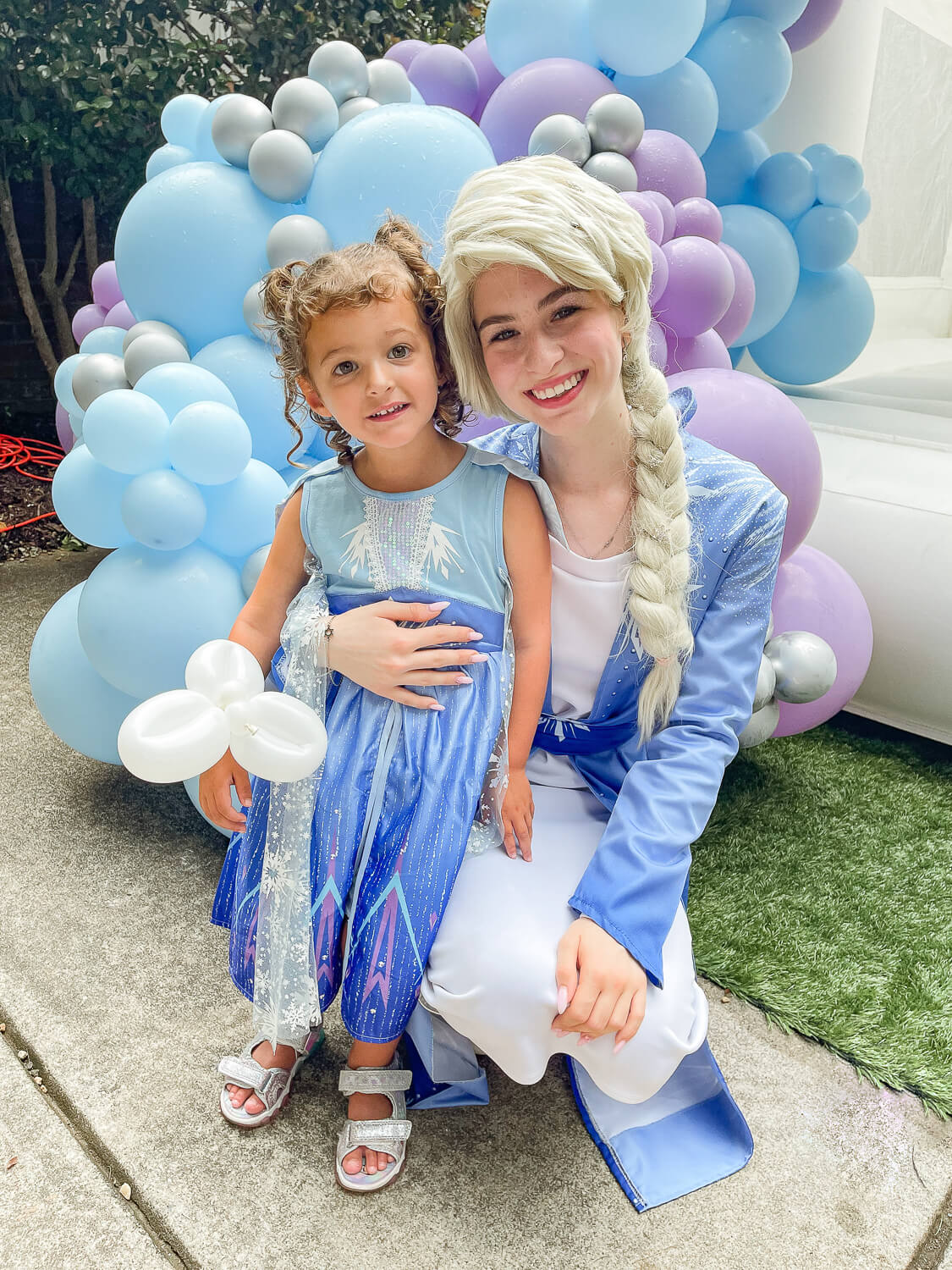 toddler girl and woman dressed like Elsa from Frozen