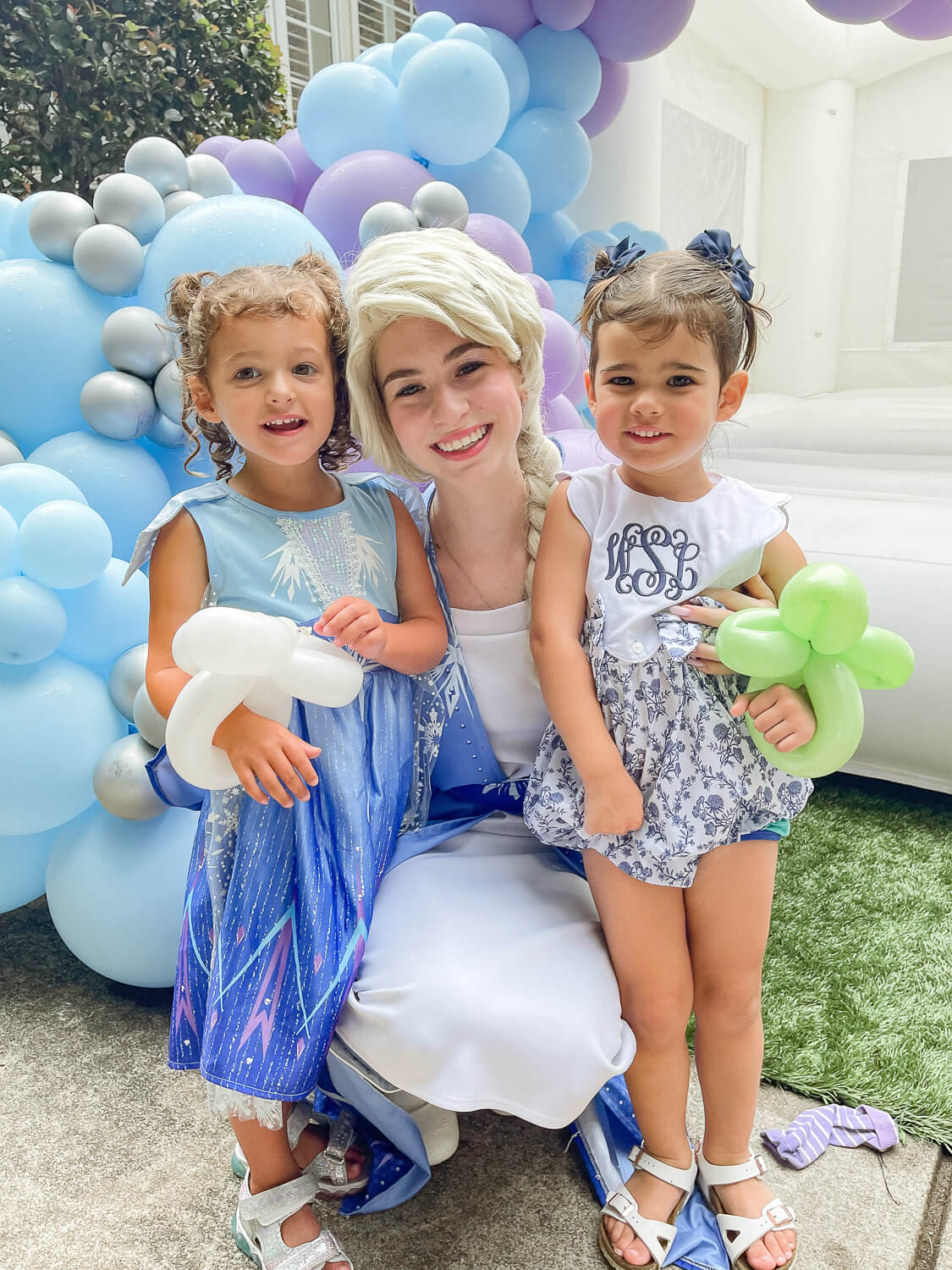 toddler girl and woman dressed like Elsa from Frozen