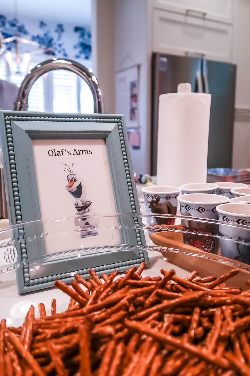 olaf's arms in front of pretzel rods